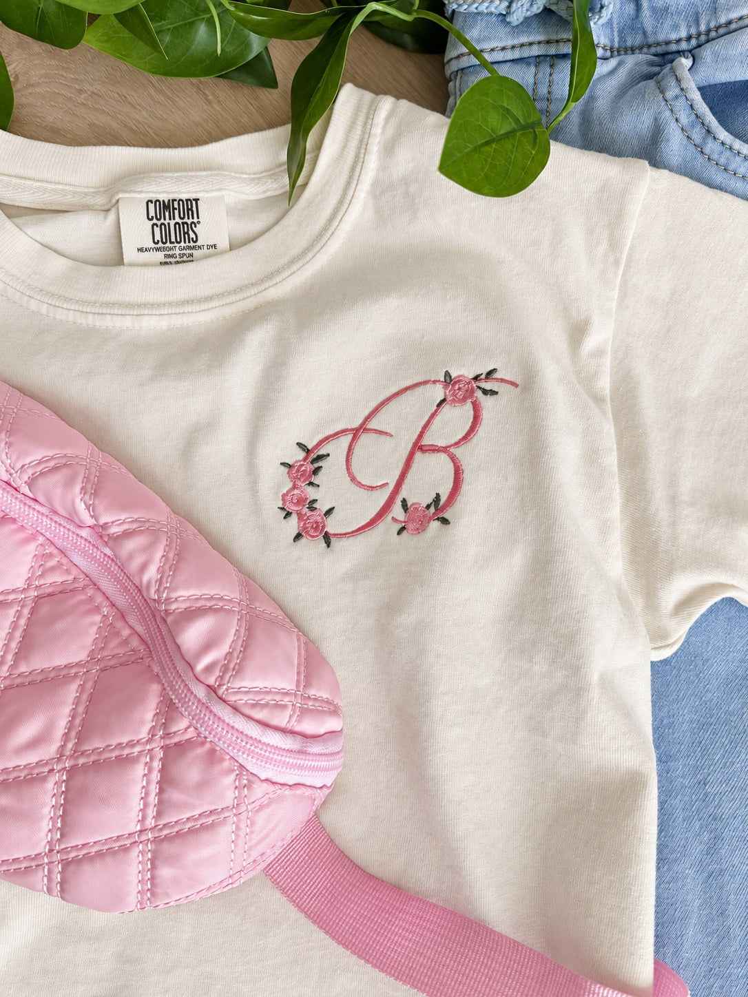 Sample: floral initial B embroidered in pink with pink roses and green leaves, on an ivory youth tee